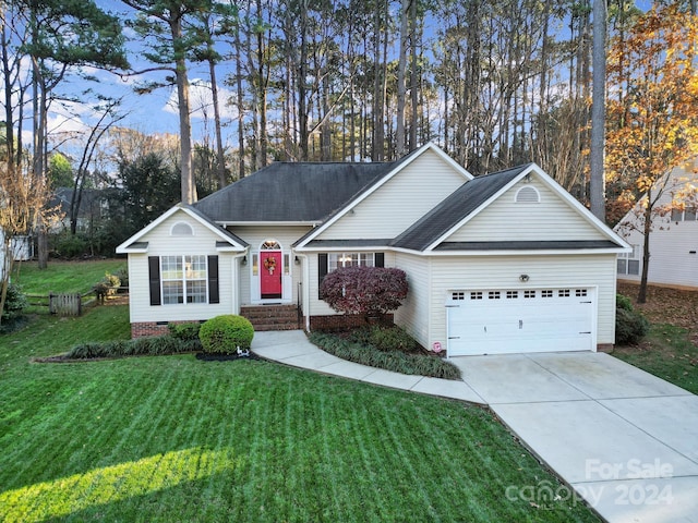 ranch-style house featuring a garage and a front lawn