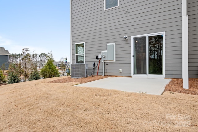 back of property with cooling unit and a patio area