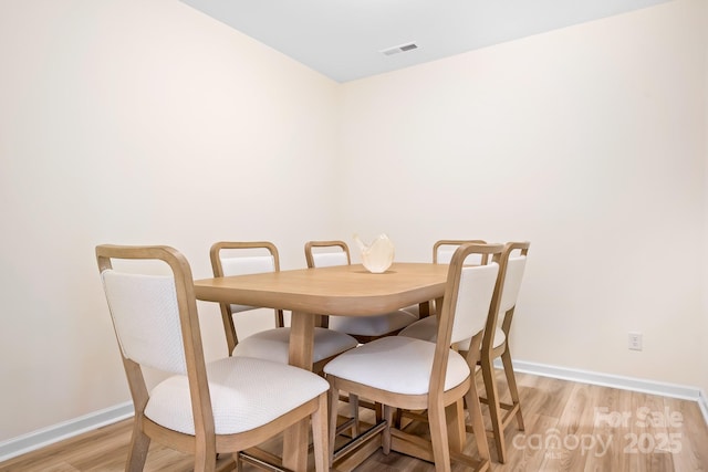 dining area featuring light wood-type flooring