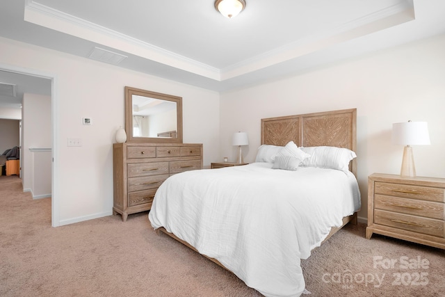 carpeted bedroom with ornamental molding and a raised ceiling