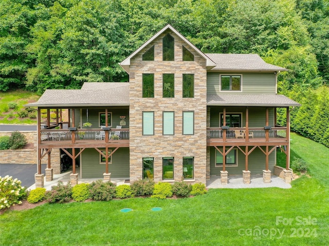 rear view of house featuring a yard and a patio