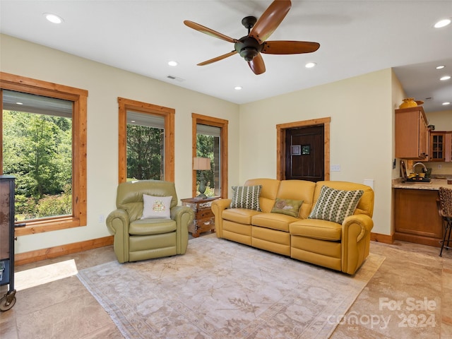 living room with ceiling fan and sink