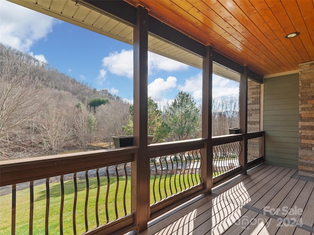 wooden terrace with a yard