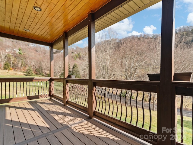 wooden deck featuring a yard