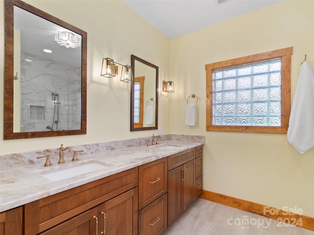 bathroom featuring vanity and tiled shower