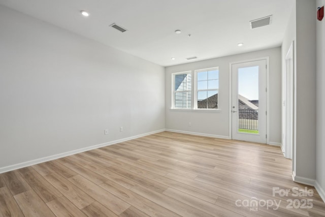 spare room featuring light wood-type flooring