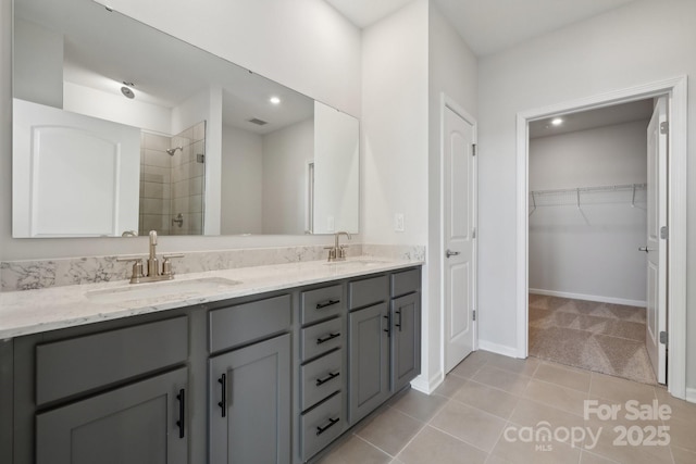 bathroom featuring walk in shower, vanity, and tile patterned flooring