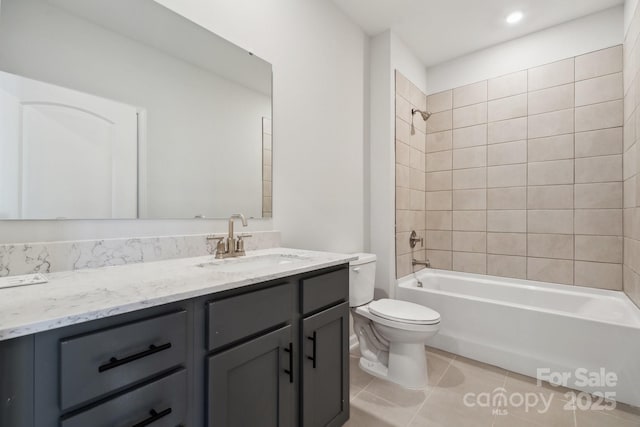 full bathroom featuring tile patterned flooring, vanity, tiled shower / bath combo, and toilet