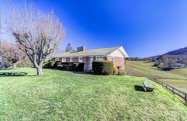 view of front facade featuring a rural view and a front yard