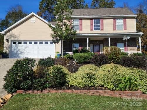 view of front of property featuring a garage and a porch