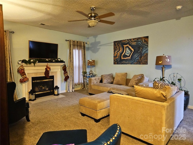 carpeted living room with ceiling fan and a textured ceiling