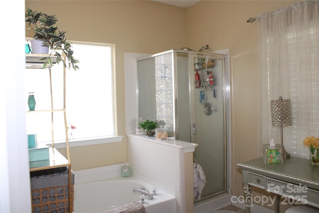 bathroom featuring shower with separate bathtub