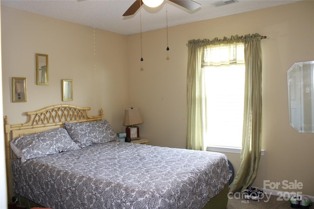 bedroom featuring multiple windows and ceiling fan