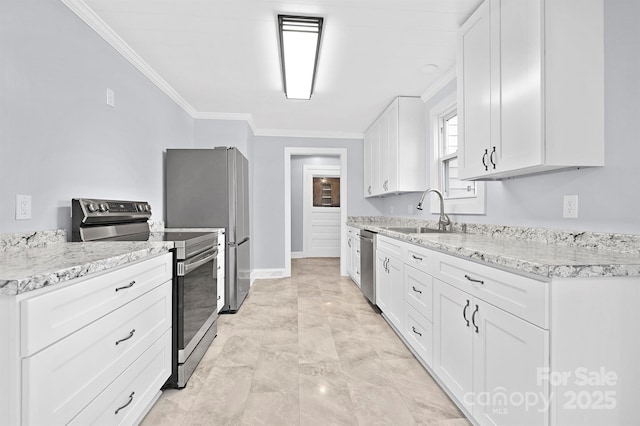 kitchen with appliances with stainless steel finishes, light stone counters, ornamental molding, sink, and white cabinetry