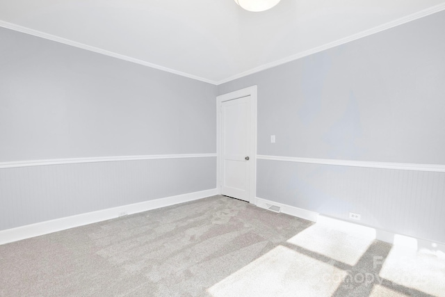 empty room featuring light carpet and ornamental molding