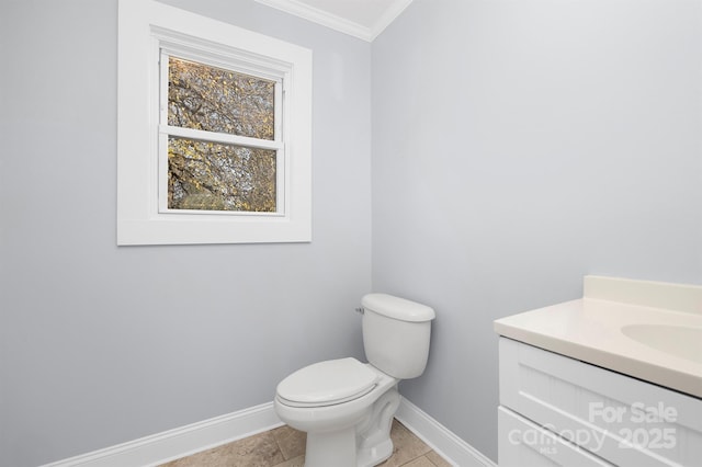 bathroom featuring vanity, toilet, plenty of natural light, and ornamental molding