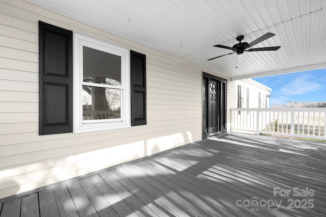 wooden terrace featuring ceiling fan and covered porch