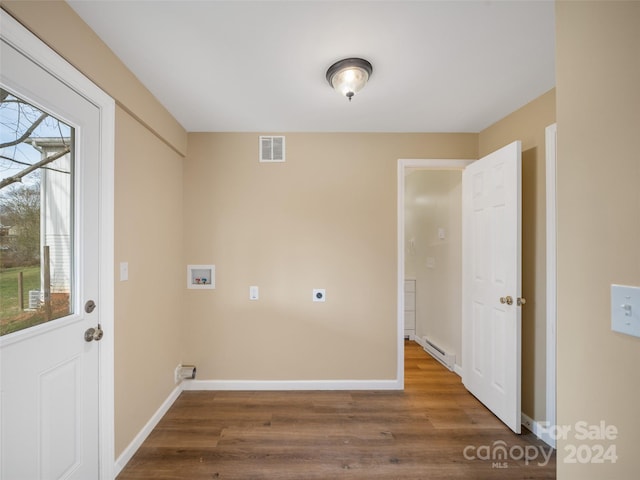 washroom featuring washer hookup, electric dryer hookup, dark wood-type flooring, and a baseboard heating unit