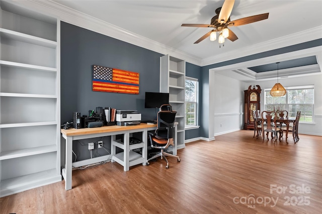 office featuring hardwood / wood-style flooring, built in features, ceiling fan, and crown molding