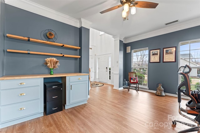 interior space with ceiling fan, light hardwood / wood-style floors, and ornamental molding