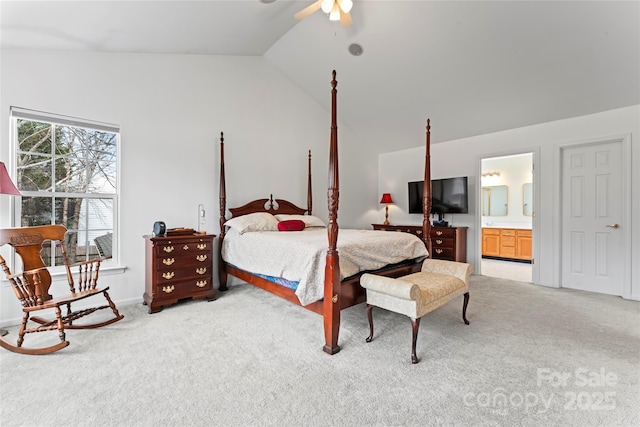 bedroom featuring carpet flooring, ceiling fan, vaulted ceiling, and ensuite bath