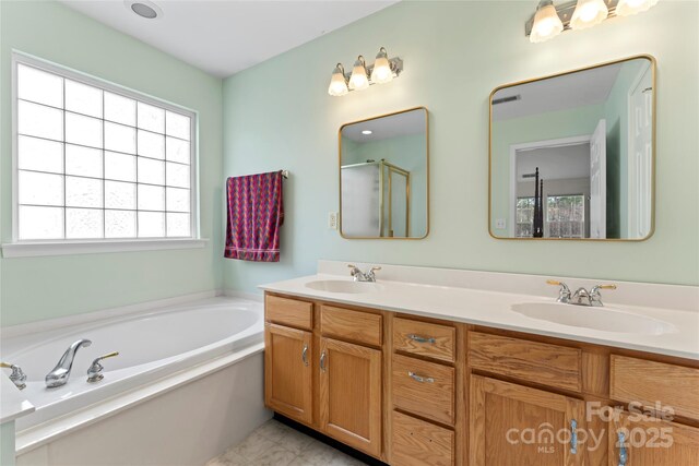 bathroom featuring shower with separate bathtub and vanity