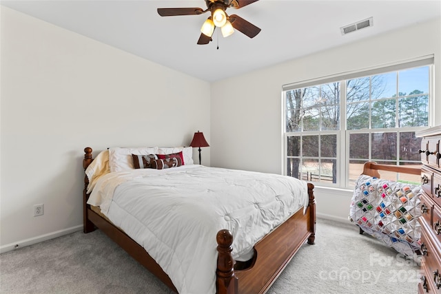 bedroom featuring ceiling fan and light carpet