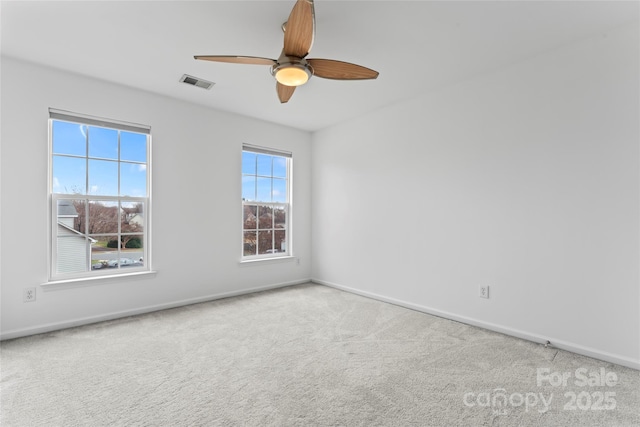 empty room with ceiling fan and carpet floors