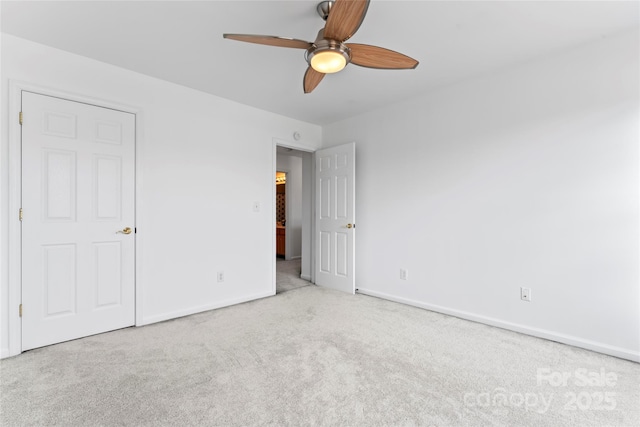 unfurnished bedroom featuring ceiling fan and light colored carpet