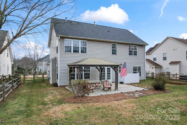 back of property featuring a gazebo, a patio area, and a yard