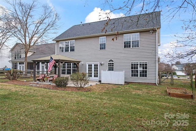 rear view of house featuring a gazebo, a patio area, a yard, and french doors