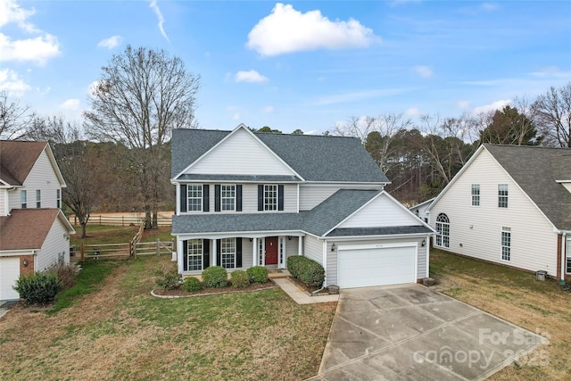 front facade featuring a front yard and a garage