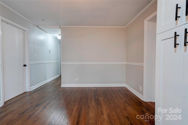 unfurnished room with a textured ceiling, dark hardwood / wood-style flooring, and crown molding