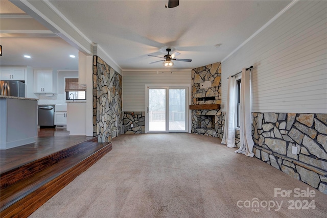 living room featuring ceiling fan, dark carpet, sink, and crown molding