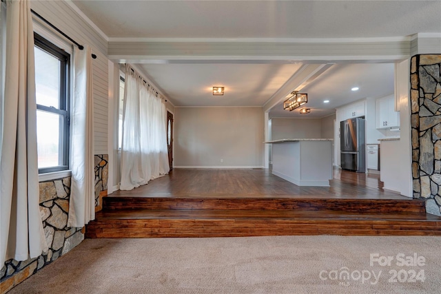 empty room featuring ornamental molding and dark wood-type flooring