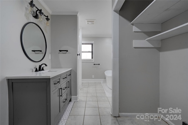 bathroom featuring tile patterned flooring, vanity, and crown molding