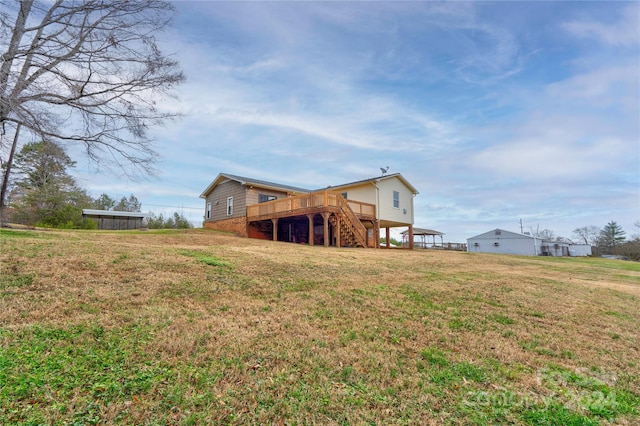 rear view of property with a lawn and a wooden deck