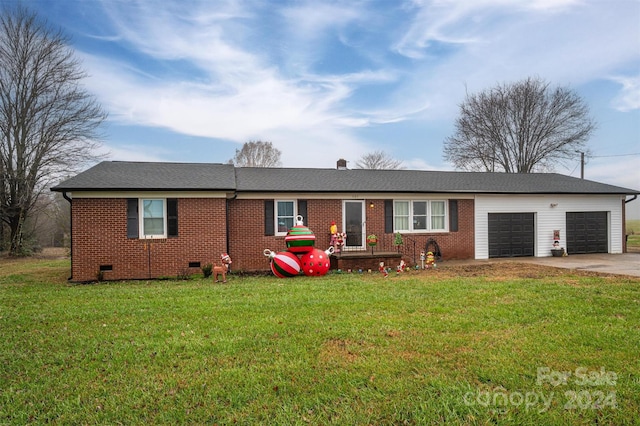 ranch-style home with a front yard and a garage