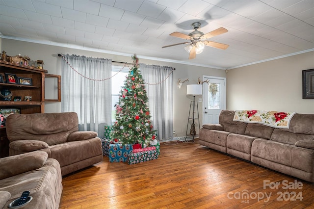 living room featuring wood-type flooring, ceiling fan, and ornamental molding