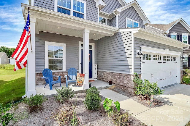 view of front of house featuring covered porch and a garage