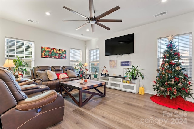 living room with ceiling fan and light wood-type flooring