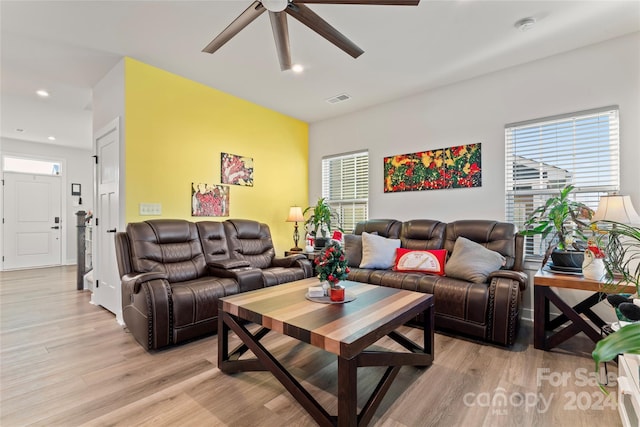 living room with ceiling fan, plenty of natural light, and light hardwood / wood-style floors