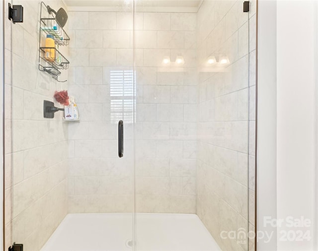 bathroom with a shower with shower door