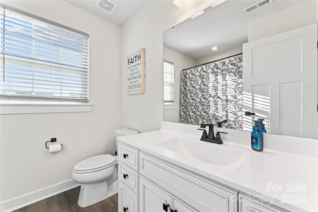 bathroom featuring hardwood / wood-style floors, vanity, toilet, and a shower with shower curtain