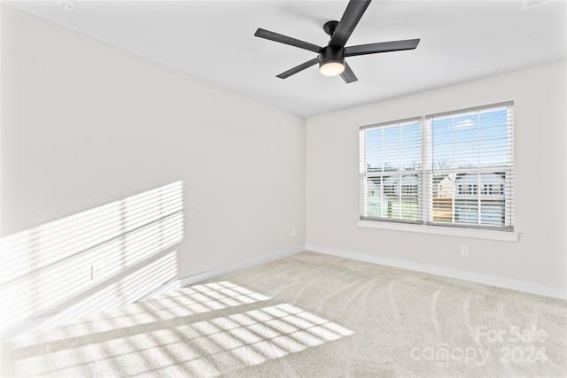 carpeted empty room featuring ceiling fan