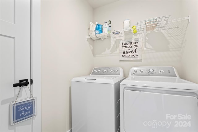 clothes washing area featuring washer and dryer