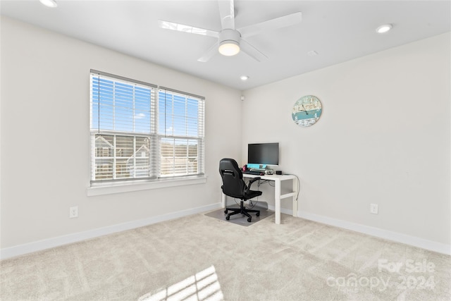 office with light carpet and ceiling fan