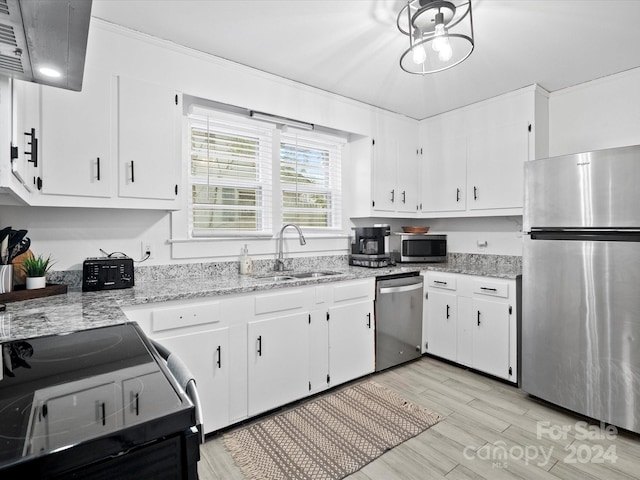 kitchen with white cabinetry, light hardwood / wood-style flooring, stainless steel appliances, and sink