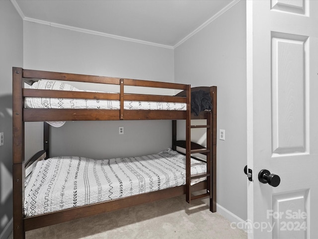 bedroom featuring crown molding and light carpet