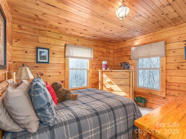 carpeted bedroom with wood walls, wooden ceiling, and multiple windows